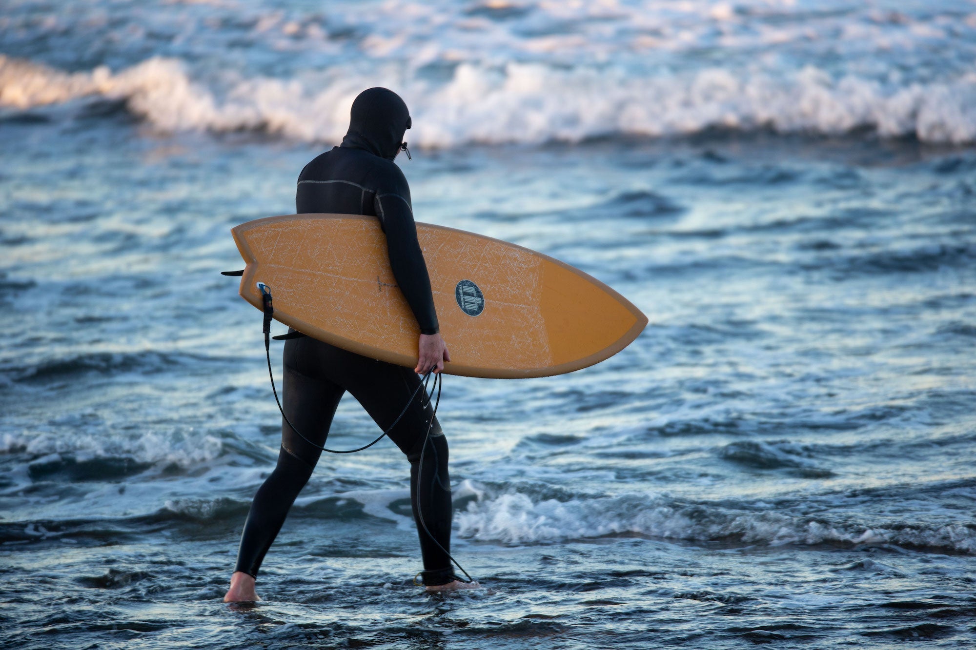 A display of essential wetsuit accessories like boots, gloves, and hoods at our The Hague shop. Noordzee Boardstore surfshop Surfschool webshop surfboardrepairs Scheveningen