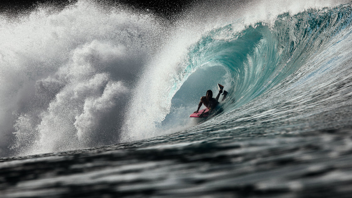 Person having fun in the waves with a durable bodyboard from our surfshop in The Hague. Noordzee Boardstore surfshop Surfschool webshop surfboardrepairs Scheveningen
