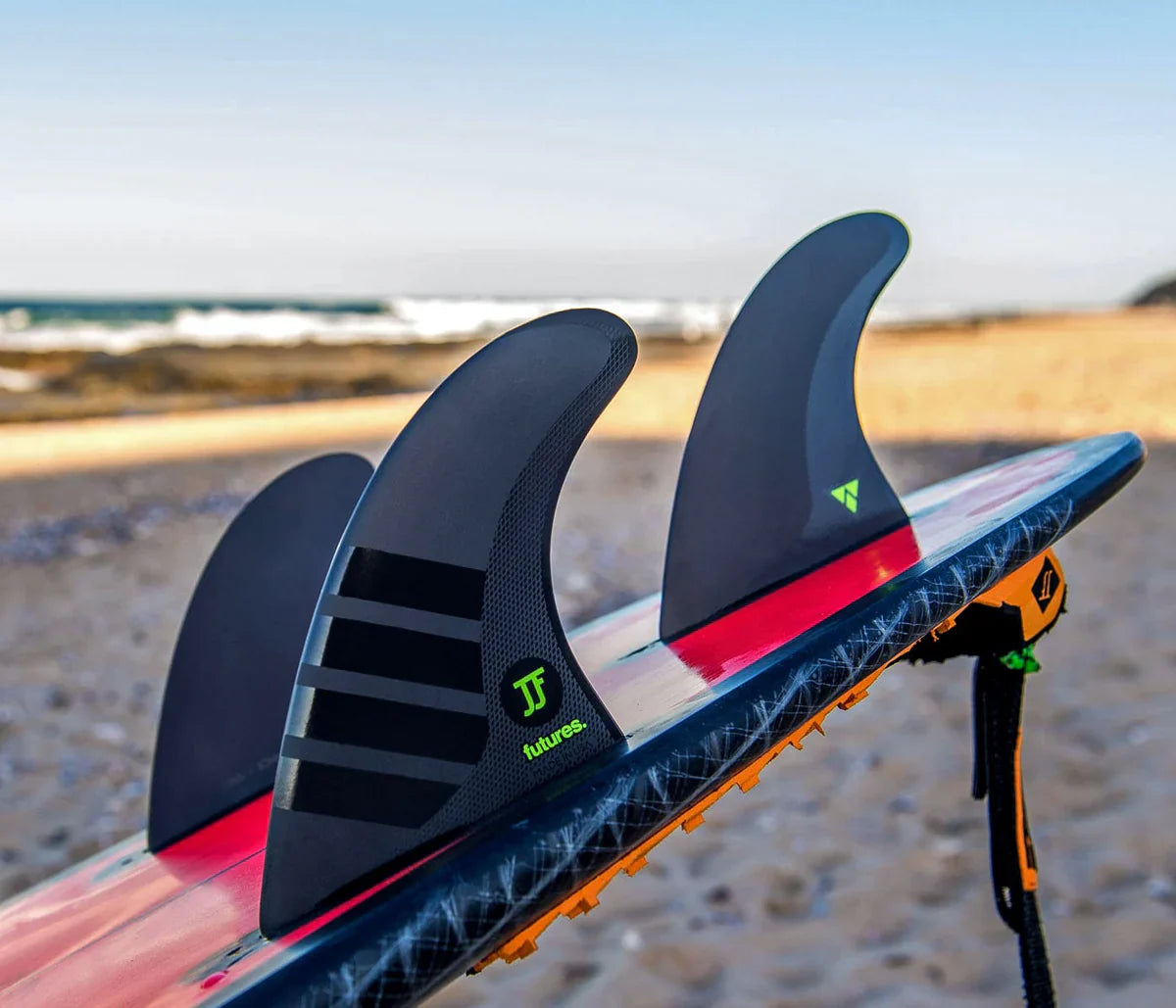 A person holding a strong and reliable set of Futures Fins from the Noordzee Boardstore collection. Noordzee Boardstore surfshop Surfschool webshop surfboardrepairs Scheveningen
