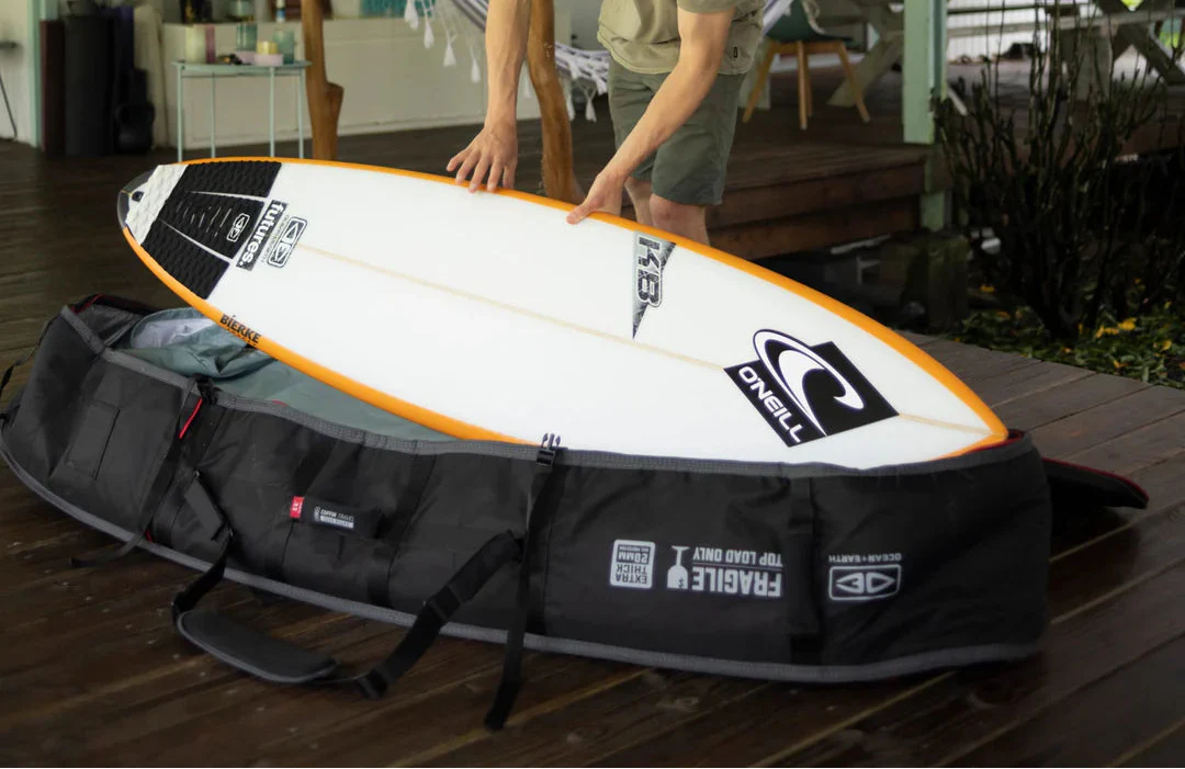 Surfer ready for a big trip, packing their quiver into a heavy-duty 3+ boardbag from our travel range. Noordzee Boardstore surfshop Surfschool webshop surfboardrepairs Scheveningen