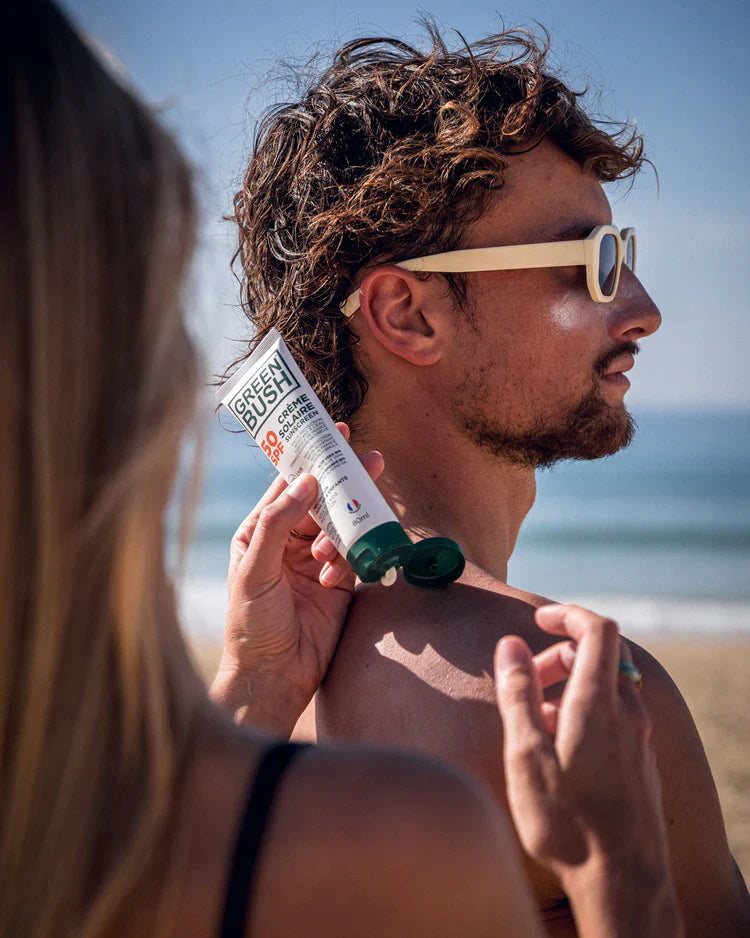 Surfer applying zinc sun protection before heading out into the waves, available at our shop. Noordzee Boardstore surfshop Surfschool webshop surfboardrepairs Scheveningen